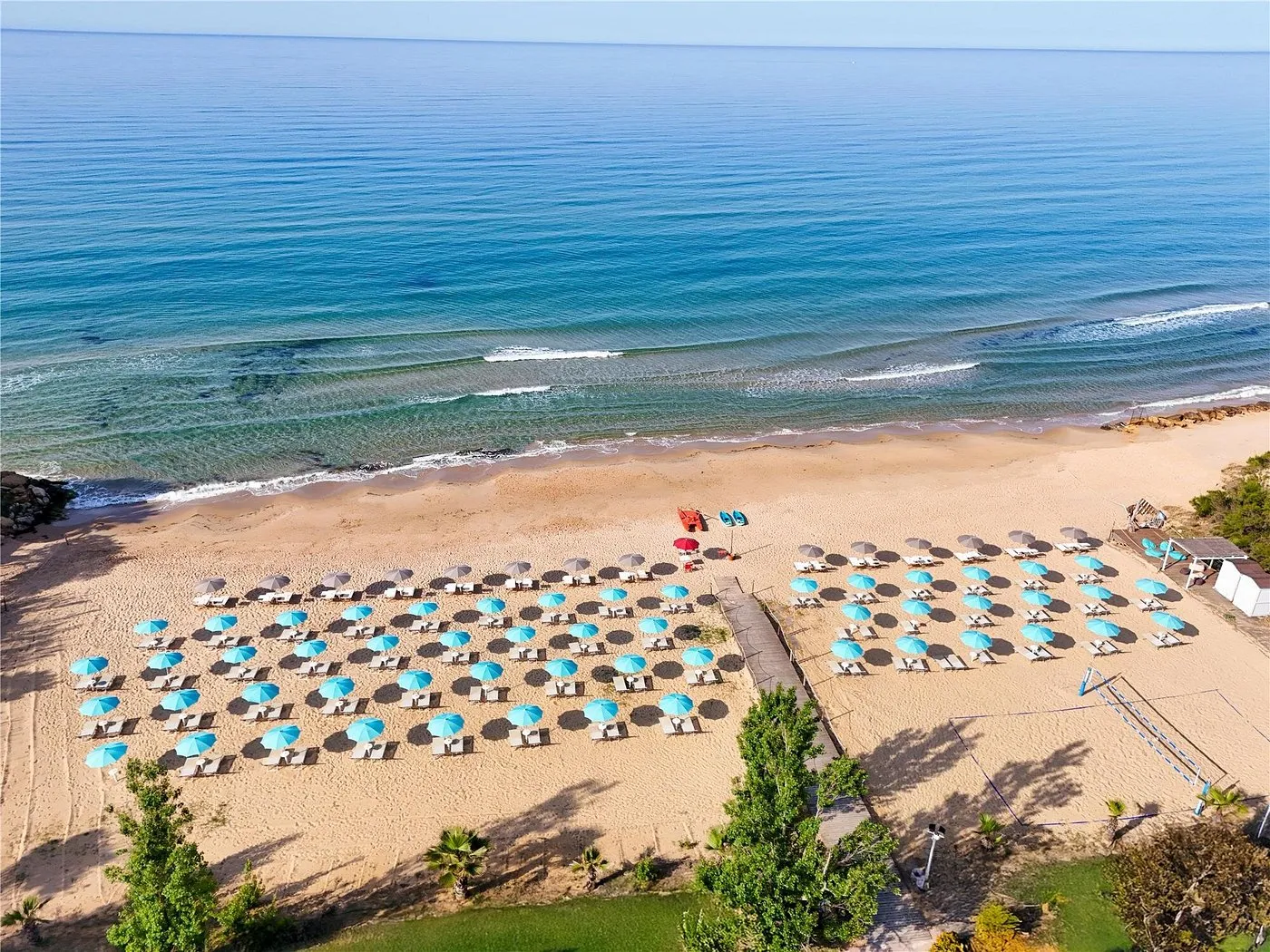 Vista aerea della spiaggia con ombrelloni azzurri sul mare