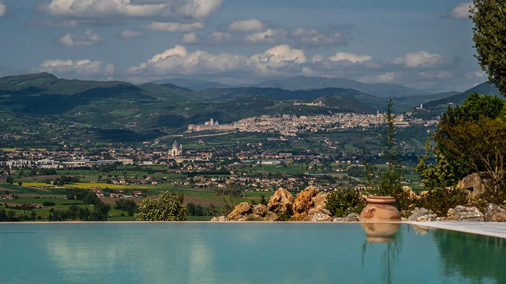 Vista panoramica su Assisi e la valle umbra dalla piscina del casale
