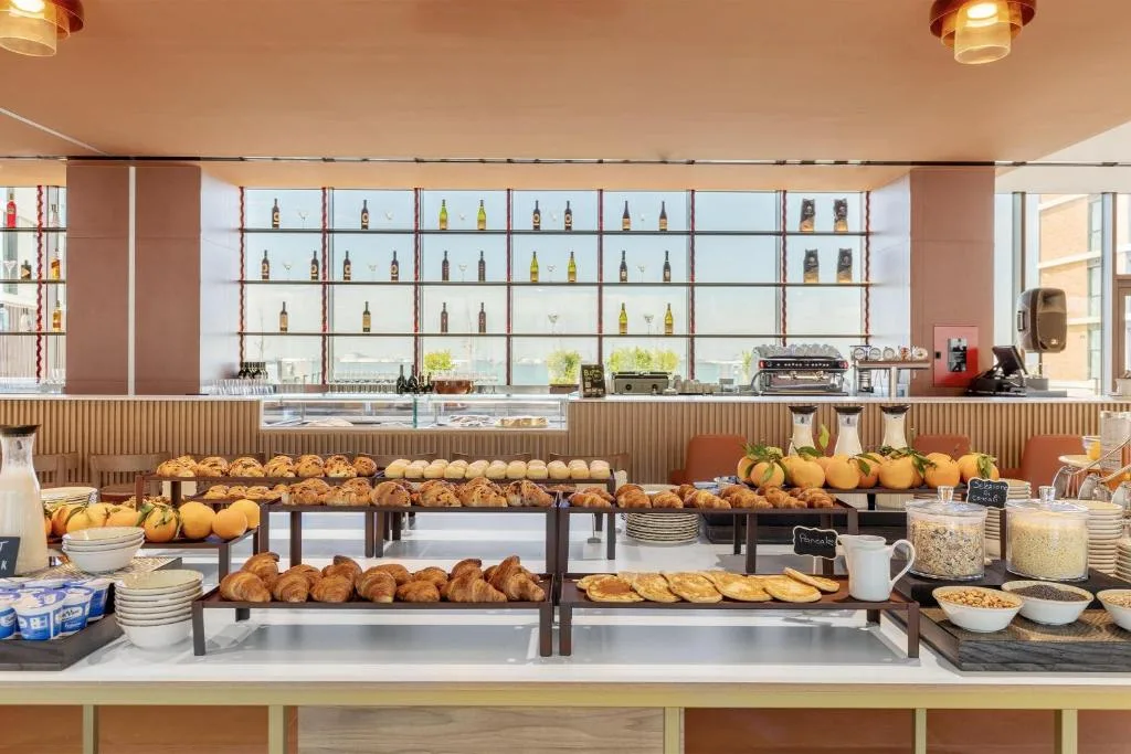 Ricco buffet della colazione con pane, cornetti e cereali