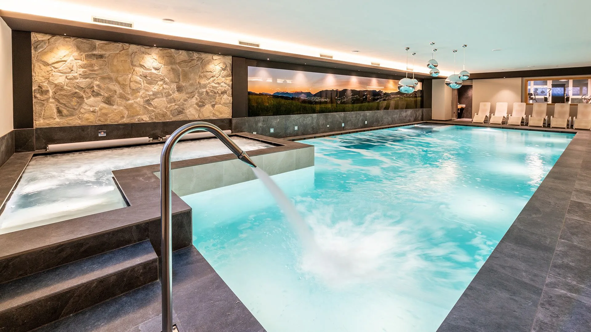 Piscina coperta con getto d'acqua, area idromassaggio e ambiente rilassante