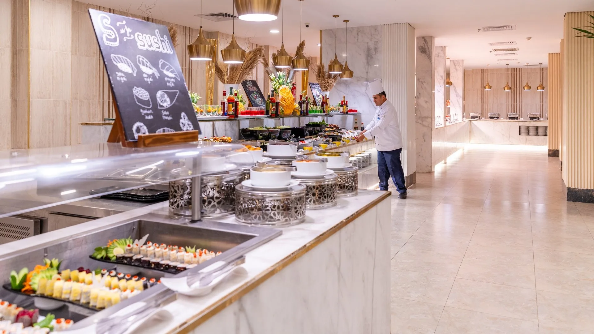 Buffet del ristorante con chef e vasta selezione di piatti e sushi